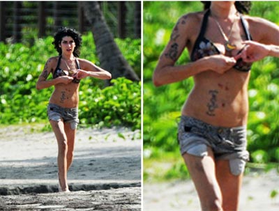 Amy Winehouse  clicada com machucados pelo corpo no Caribe