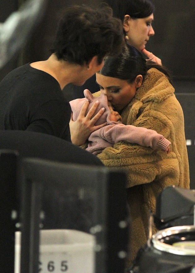 Kim Kardashian beija filha durante embarque em Nova York