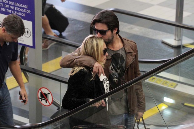 Susana Vieira e Sandro Pedroso trocam carinhos em aeroporto